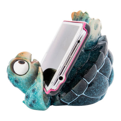 A whimsical and handcrafted figurine featuring a charming sea turtle design, providing a secure and stylish resting place for your phone