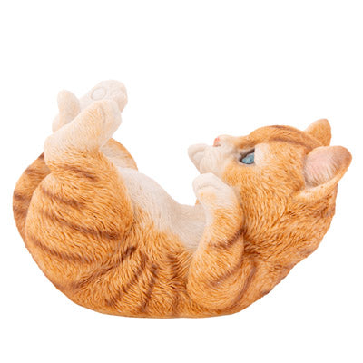 An orange tabby cat plush toy lying on its back with its paws in the air, isolated on a white background.