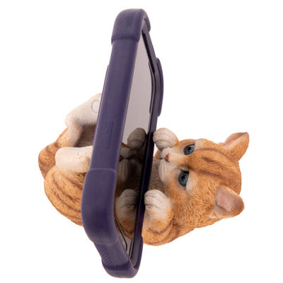 A purple phone case with a 3D orange tabby cat figurine attached underneath, shown on a plain white background.