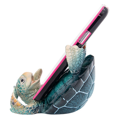 Phone holder shaped like a turtle with pink accents on a white background