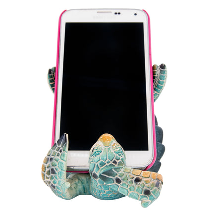 Phone holder shaped like a turtle with a smartphone on a white background