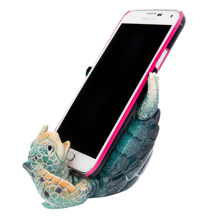 Phone holder shaped like a turtle with a smartphone on a white background