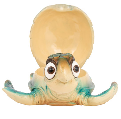 Whimsical blue cartoon turtle figurine with large bug eyes and a functional hinged shell for storing jewelry or trinkets; shown as both coastal wall art and a tabletop decorative box.