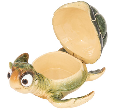Bright green cartoon turtle figurine with big bug eyes and an opening shell used as a trinket box, displayed as coastal wall art or a decorative tabletop accessory.