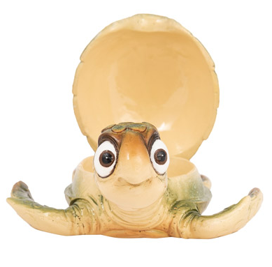 Bright green cartoon turtle figurine with big bug eyes and an opening shell used as a trinket box, displayed as coastal wall art or a decorative tabletop accessory.